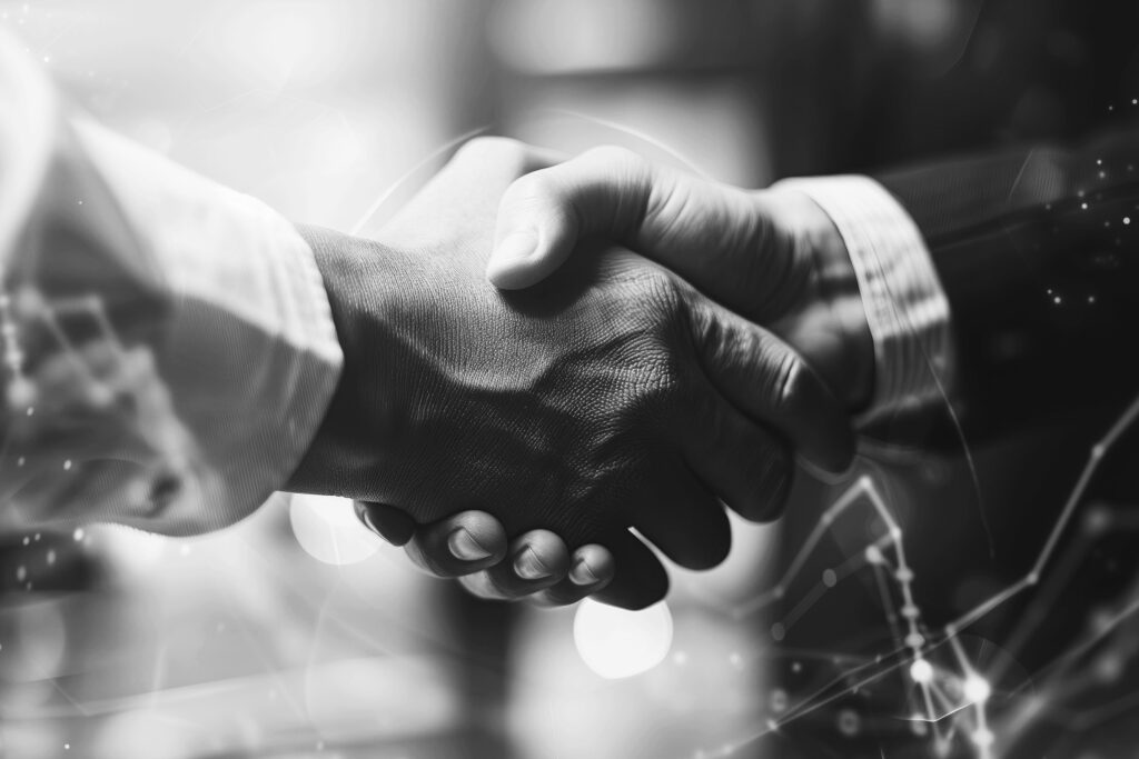 two business people shaking hands in front of a business graph